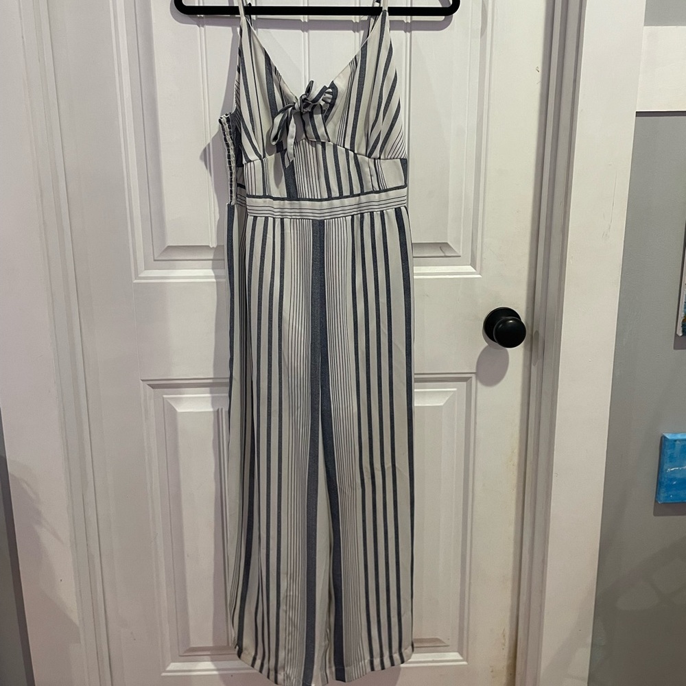White and blue grayish romper with spaghetti straps and a bow. Very breathable.